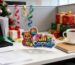 Custom acrylic standee with colorful Kai's Corner design displayed on office desk - premium UV printed acrylic desk decoration
